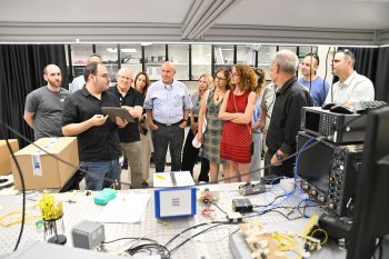 Senior lab student Alon Bernstein sharing insights into the research and work being conducted in the lab with guests during the opening of the new laboratory.